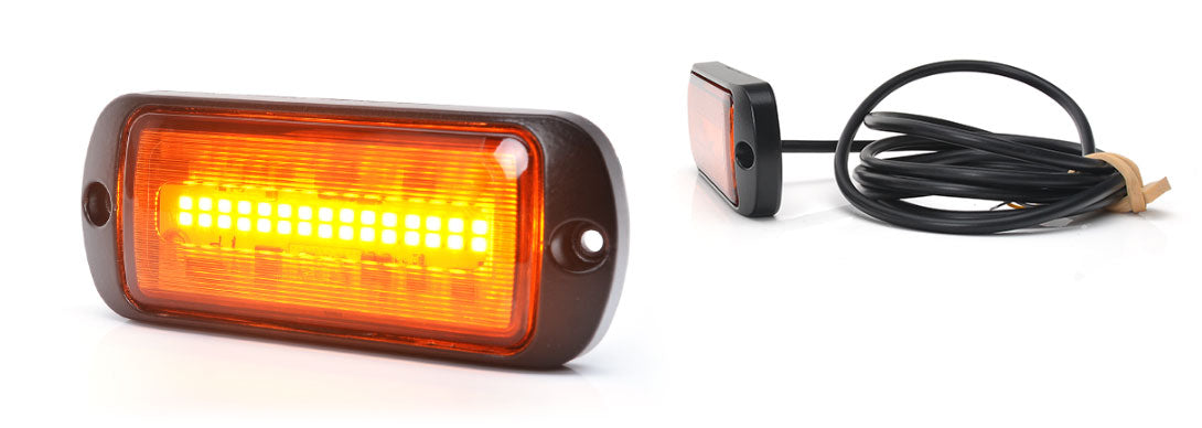 Amber LED light with power cable on a white background