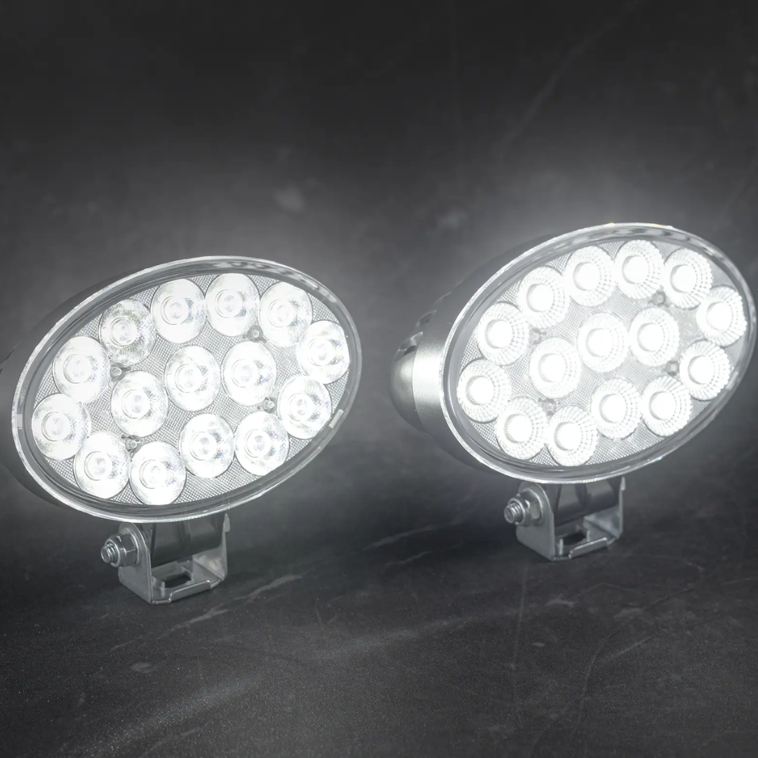 Two oval LED work lights on a dark background
