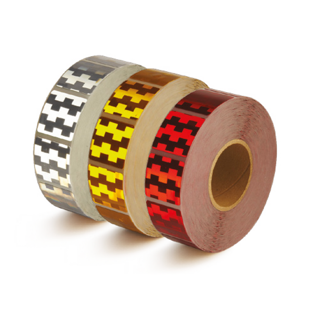 Three rolls of conspicuity tape for truck curtains patterns on a white background