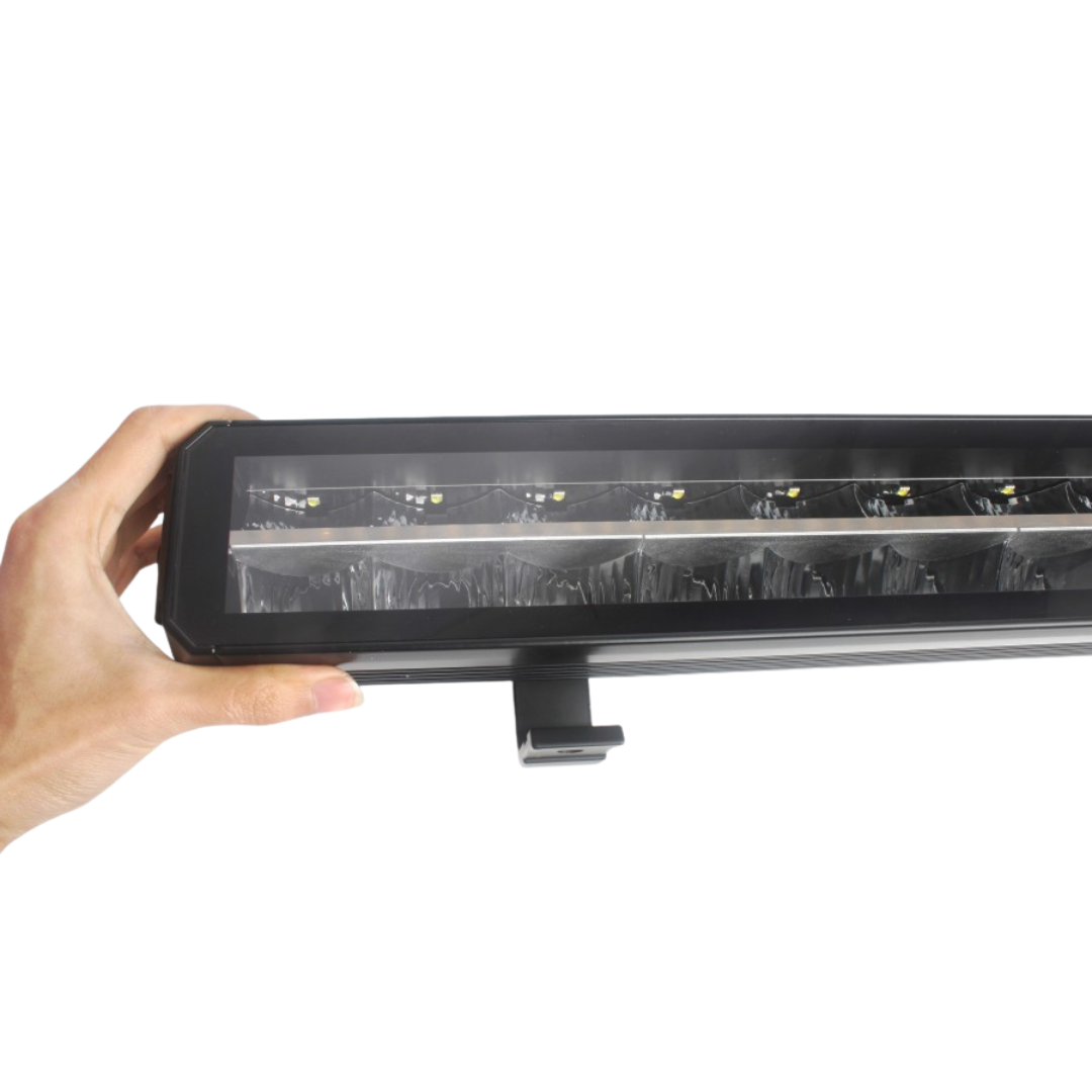 Hand holding a long rectangular light bar against a white background