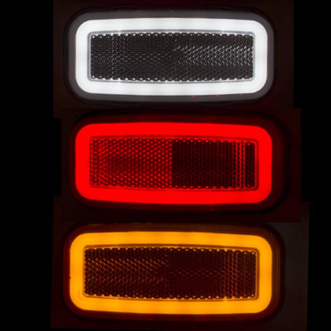 Three rectangular reflective markers in black, red, and orange on a dark background