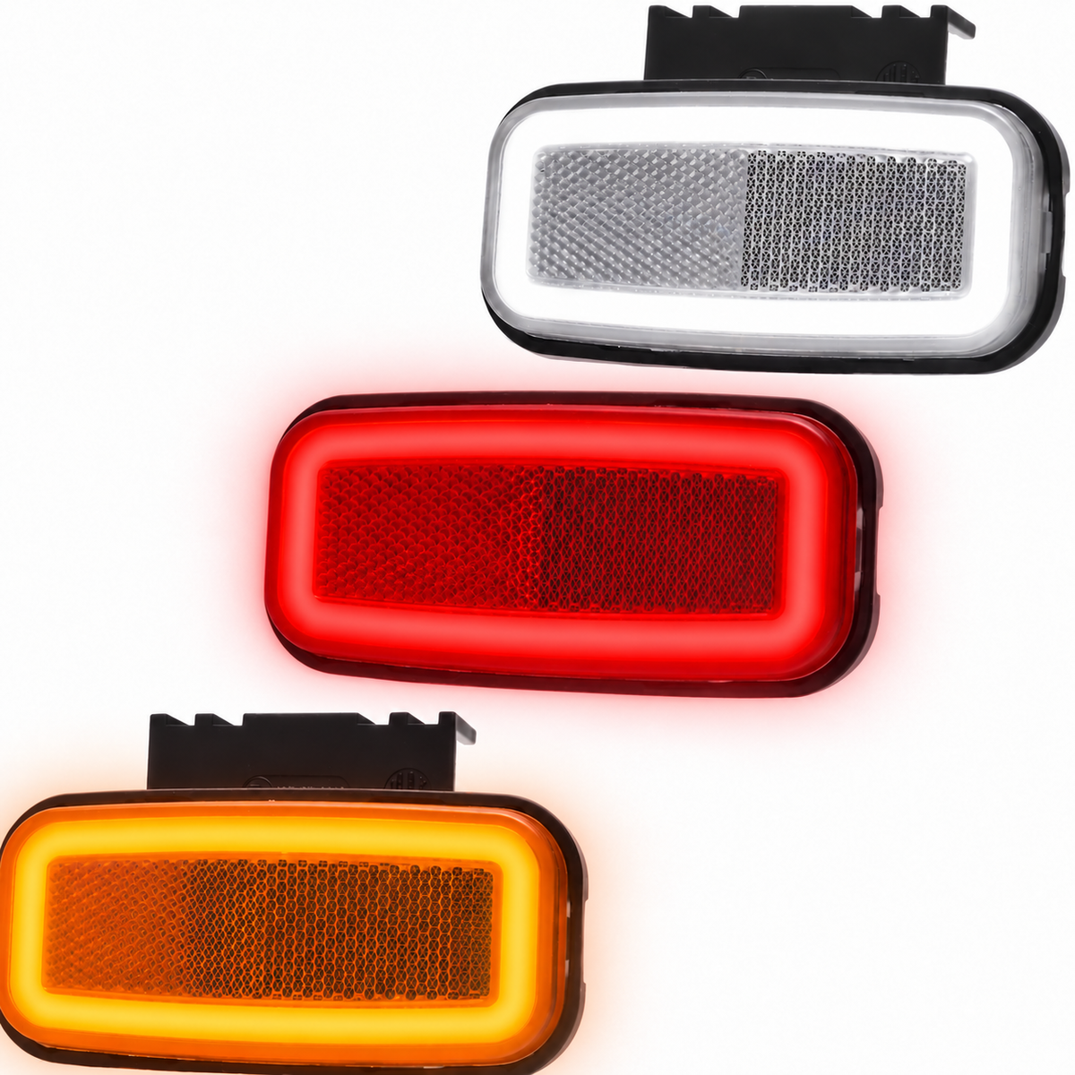 Three rectangular vehicle light reflector units shown on a white background, each illuminated in a different color: white/silver at the top, red in the middle, and amber/orange at the bottom. The units have black mounting brackets visible at the top.